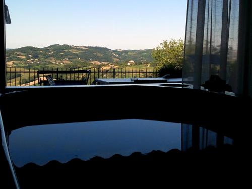 a reflection of a balcony with a view of a mountain at Albergo Diffuso - Il Poggetto tra Urbino & San Marino in Urbino