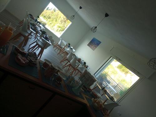 a room with a bunch of chairs and a window at Casa Vittoria Guest House in Romano D'Ezzelino
