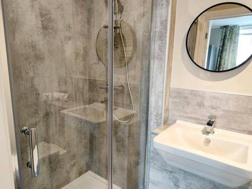 a bathroom with a shower and a sink and a mirror at Carvetii - ANNE House Room 2 - Dbl bed First floor en-suite in Carlisle