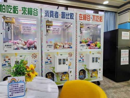 a couple of claw machines in a room at Hua Ku Hotel in Tainan