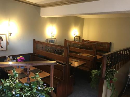 a room with benches and tables in a room at The Victoria Hotel in Pwllheli