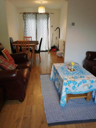 a living room with a table and a couch at Beacons view in Hirwaun