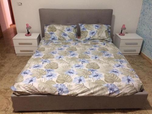 a bedroom with a bed with blue flowers on it at Monolocale Palombara Sabina in Cretone