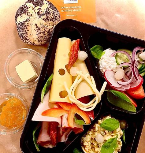 a tray of food with vegetables and cheese on a table at ZAKOPIANA in Zakopane