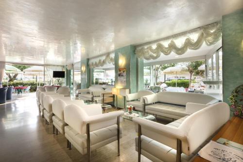 a waiting room with white couches and chairs at Hotel Margareth in Riccione