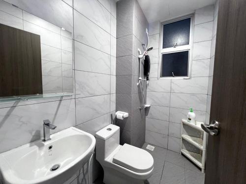 a white bathroom with a toilet and a sink at SKS Habitat Larkin Economy Business Unit in Johor Bahru