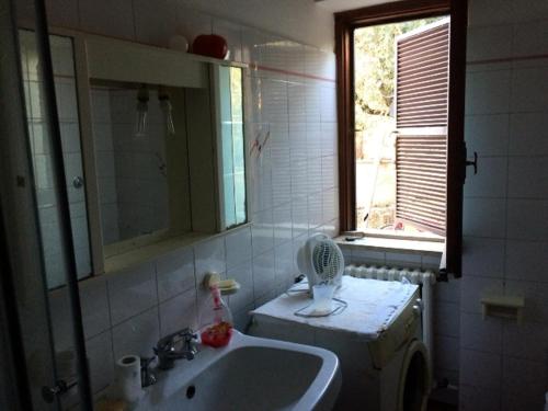 a bathroom with a sink and a fan on the counter at Monolocale Palombara Sabina in Cretone