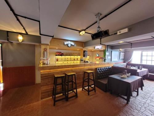 a restaurant with a bar with a table and stools at Oak valley retreat in Pelling