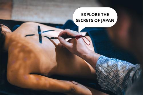a woman getting a tattoo on her back with a needle at OROOM Japan - Role Play For Couples in BRNO in Brno