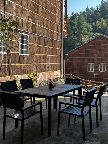 a black table and chairs on a patio at Tongfu Inn(In the National Park) in Zhangjiajie