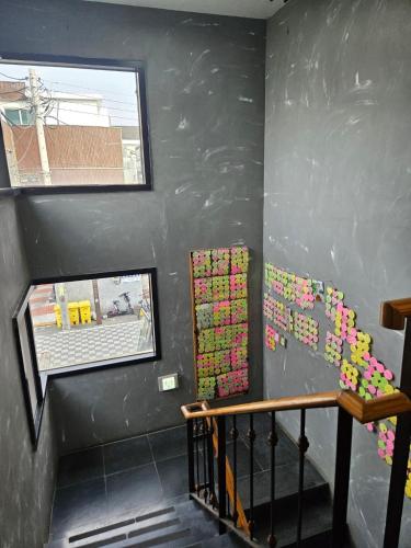 a staircase with pink sticky notes on the wall at Gyeongju BonghwangMansion in Gyeongju