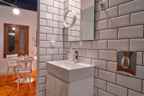 a white bathroom with a sink and a table at #SimpliCity Modern Design Studio in Mytilini