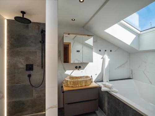 a bathroom with a sink and a shower at Alpine Homes - Hopfgarten in Hopfgarten im Brixental