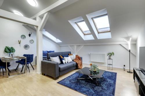 a living room with a couch and a table at Spacious Old Town LOFT for 6 in Bratislava