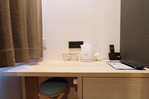 a desk with a coffee maker on top of it at Park Central Sakura Hotel in Osaka
