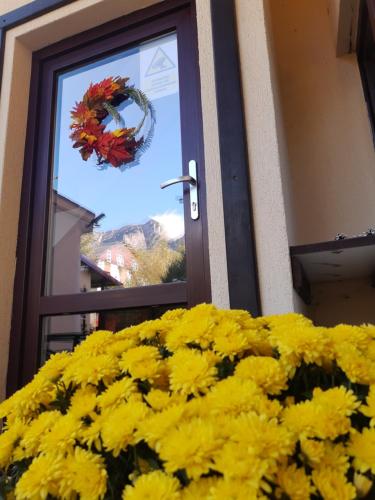 een bos gele bloemen voor een deur bij Casa cu Flori in Buşteni