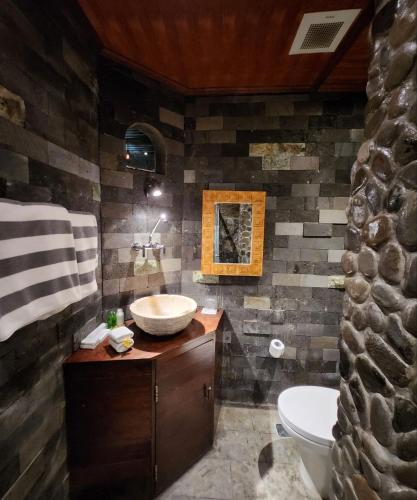 a bathroom with a sink and a toilet at Avalon Ubud Castle & SPA in Ubud