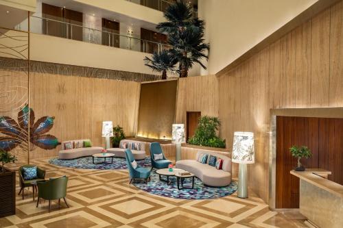 a lobby of a hotel with couches and chairs at WOW Crest, Indore - IHCL SeleQtions in Indore