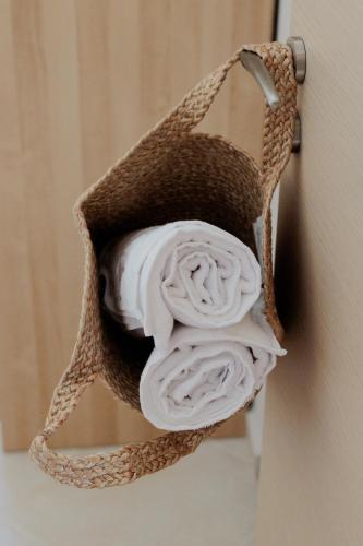 a roll of towels in a towel holder on a door at Villa GEM in Porto Rafti