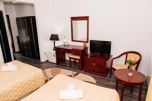 a hotel room with two beds and a mirror at Casa Octavian in Suceviţa