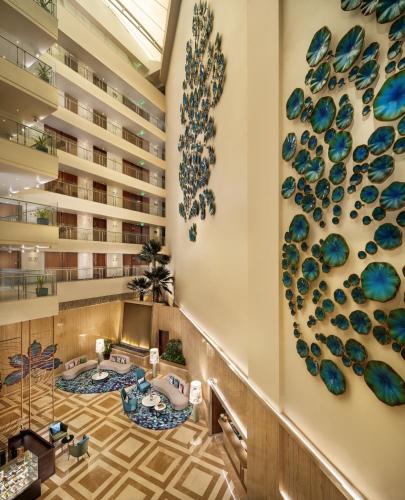 a lobby with blue glass vases on the wall at WOW Crest, Indore - IHCL SeleQtions in Indore