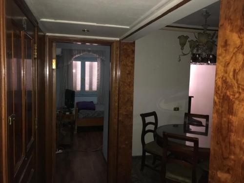 een kamer met een tafel en stoelen en een eetkamer bij In ibrahimia midtown Alex in Alexandrië