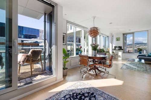 a living room with a table and chairs at Modern 2bed room sea view apartment @ Oslo Barcode in Oslo