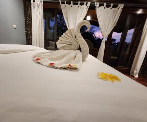 a swan on a bed with a flower on it at Avalon Ubud Castle & SPA in Ubud