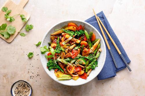 a bowl of food with vegetables on a table with chopsticks at ROBINSON Landskron in Landskron