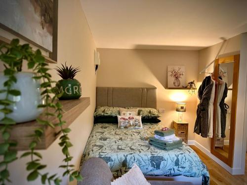 a small bedroom with a bed in the corner at Highland HotTub Retreat, on NC500 in Inverness