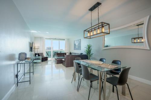 a dining room and living room with a table and chairs at OCEAN RESERVE 15th Floor - Gorgeous Ocean View - STR00907 in Miami Beach