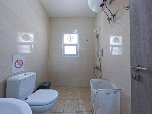 a bathroom with a toilet and a shower and a sink at Hor Al Anz Star Residence - Home Stay in Dubai