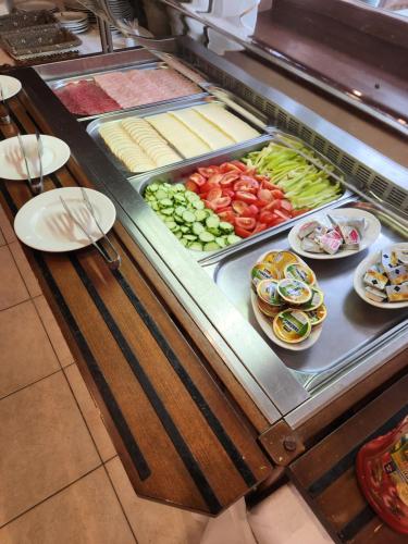 a buffet with many different types of food on display at Hotel Autis in Vysoké Tatry
