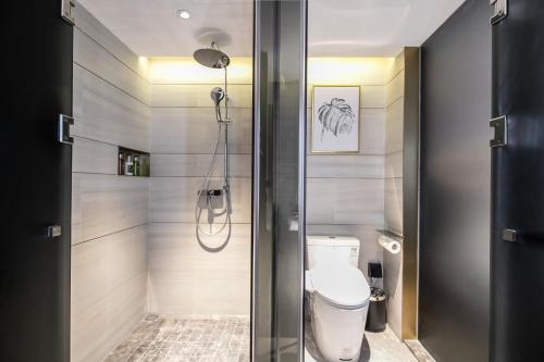 a bathroom with a toilet and a shower stall at Echarm PLUS Hotel Guangzhou Beijing Road Pedestrian Street Dafo Ancient Temple in Guangzhou