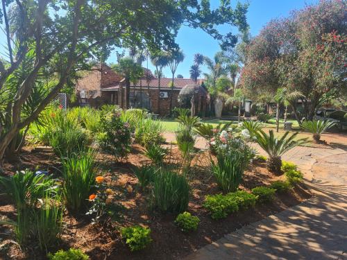a garden in front of a house with plants at Royal Villa Guesthouse in Brakpan