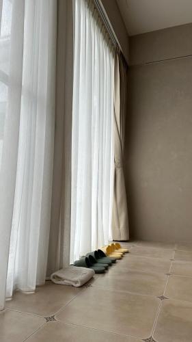 a room with a large window with white curtains at 拾嶼SheWill in Hengchun