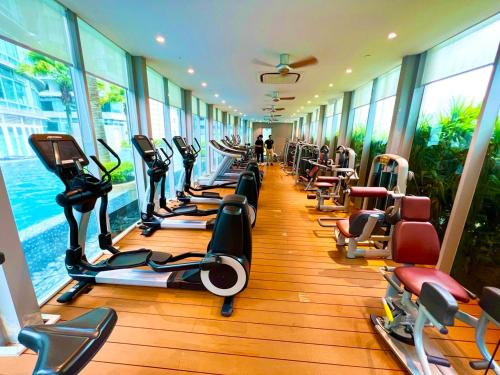 a gym with a row of treadmills and exercise bikes at Vortex city view klcc in Kuala Lumpur