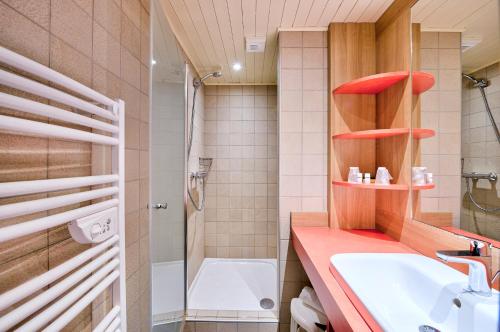 a bathroom with a sink and a toilet and a tub at Village Club Les Tavaillons in Les Carroz d'Araches