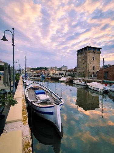 a boat is docked at a dock in a harbor at Hotel Smart Cervia B&B in Cervia