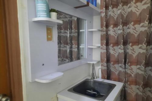 een badkamer met een wastafel en een spiegel bij OYO Life 93160 Kost Jenny Karawang in Karawang