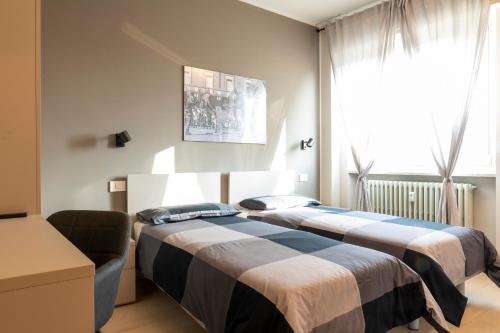 En eller flere senger på et rom på Arò Design Suite
