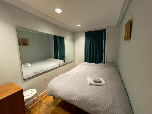 Fawlty Towers في بروكلين: غرفة نوم بسرير ومرآة كبيرة