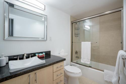 a bathroom with a toilet and a sink and a shower at OCEAN RESERVE 15th Floor - Gorgeous Ocean View - STR00907 in Miami Beach