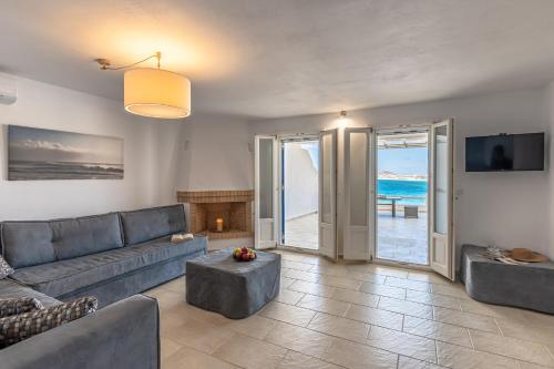 a living room with a couch and a fireplace at Apricot and Sea Luxury Villas in Mikri Vigla