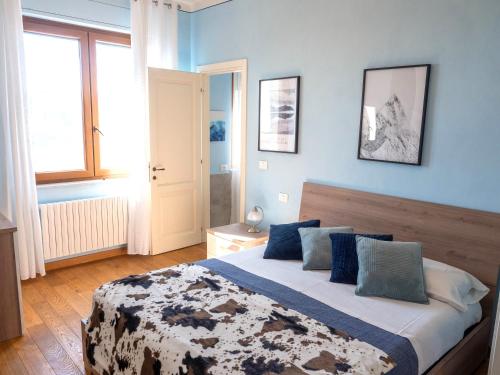 a bedroom with a large bed with blue walls at Apartment with Beautiful Sun in Montepulciano