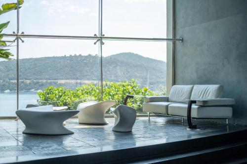 a group of chairs and a couch in front of a window at Kuum Hotel & Spa in Golturkbuku