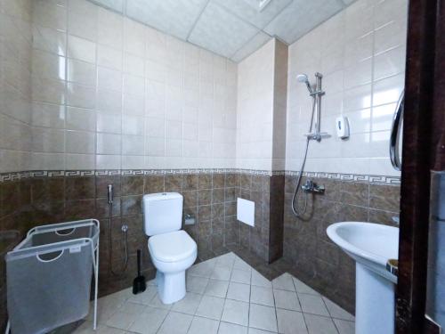 a bathroom with a toilet and a sink at Al Badaa Star Residence - Home Stay in Dubai