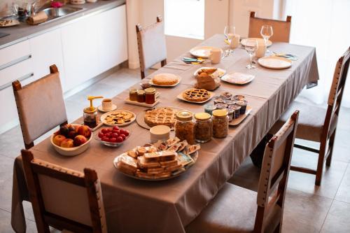 a long table with food and snacks on it at Agriturismo da Natalino in Ceggia