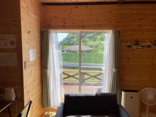 a living room with a window with a view of a porch at Koniyado Room 103 - Vacation STAY 42437v in Setouchi