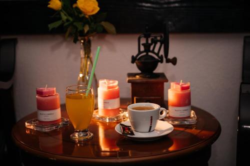 a table with a cup of coffee and a vase with candles at Casa Octavian in Suceviţa
